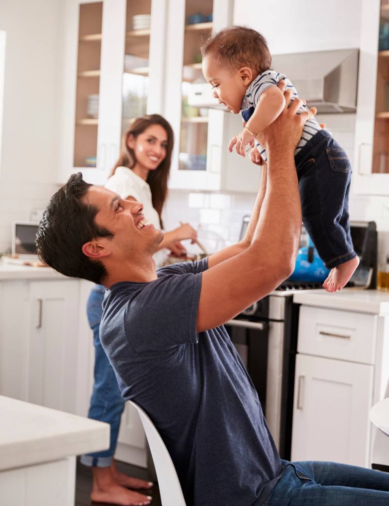 Father And Mother In Kitchen With Child